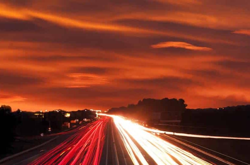 Highway at sunset with vehicle light trails